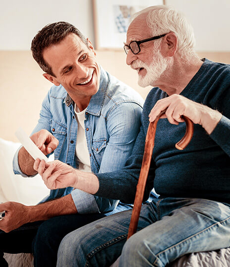 adult man takes care of elderly man