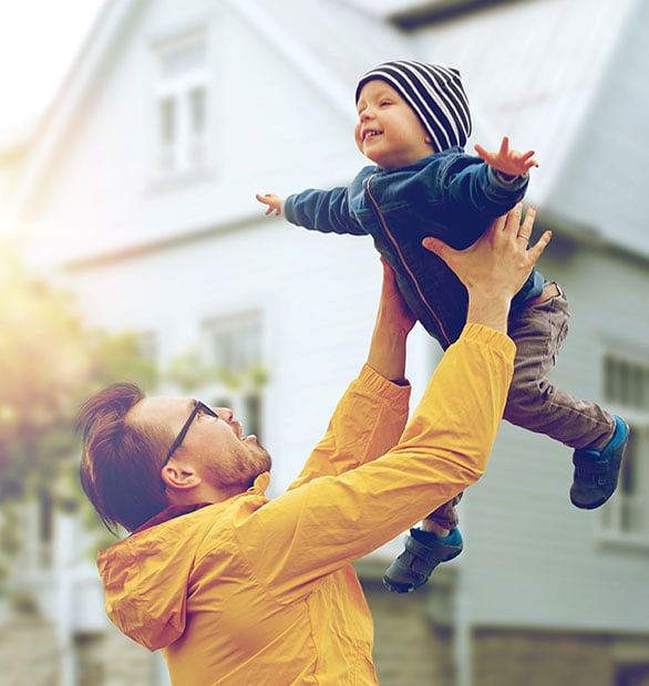 father holding child with arms outstretched in the air