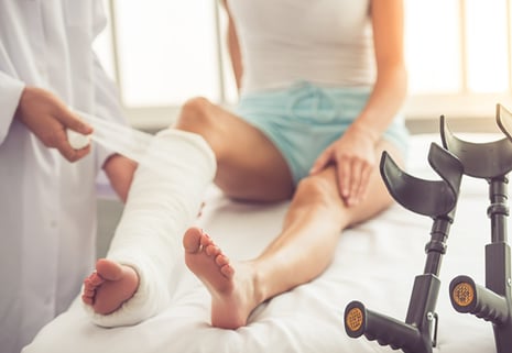 doctor putting cast on leg