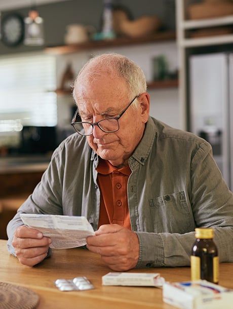 man reading medication instructions
