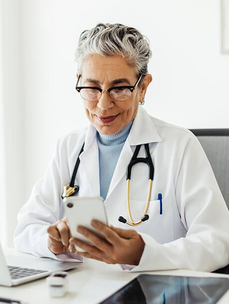 doctor looks at cell phone