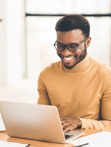 Smiling man using laptop