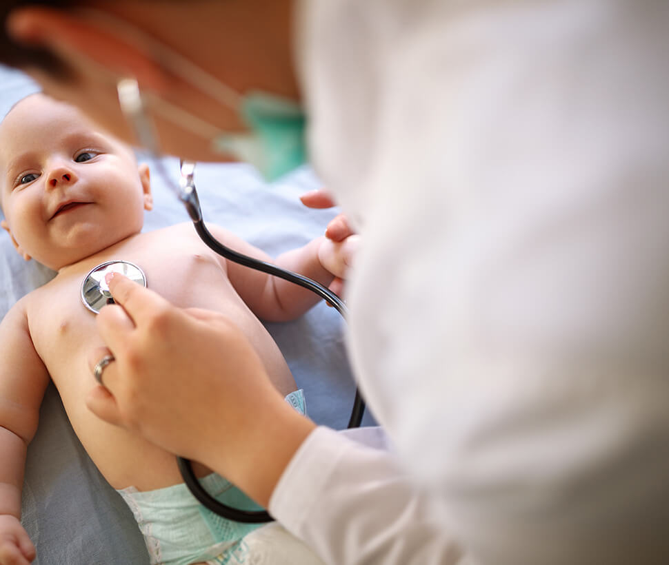 Doctor with stethoscope on baby