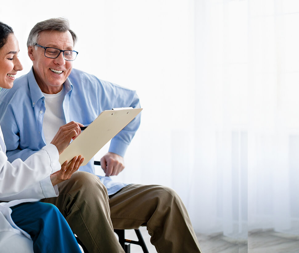 female physician seated with male patient