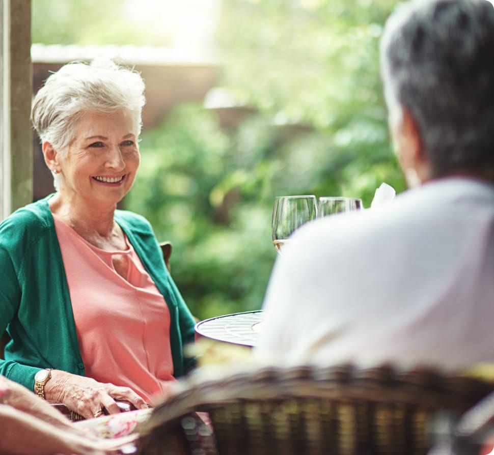 Smiling woman sitting at an outdoor table