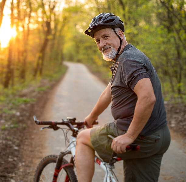 man riding bike on trail.
