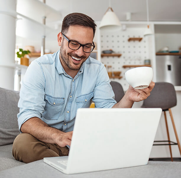 man on laptop drinking tea