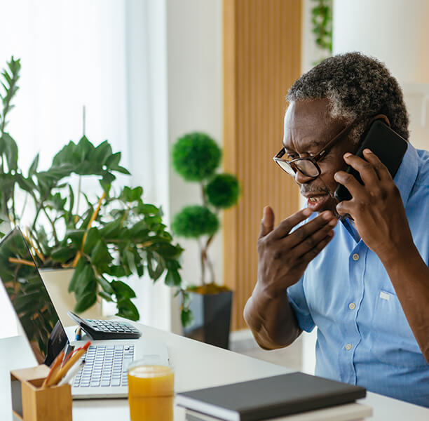 man using mobile phone at desk