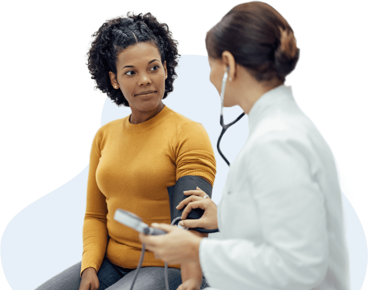 doctor taking woman's blood pressure